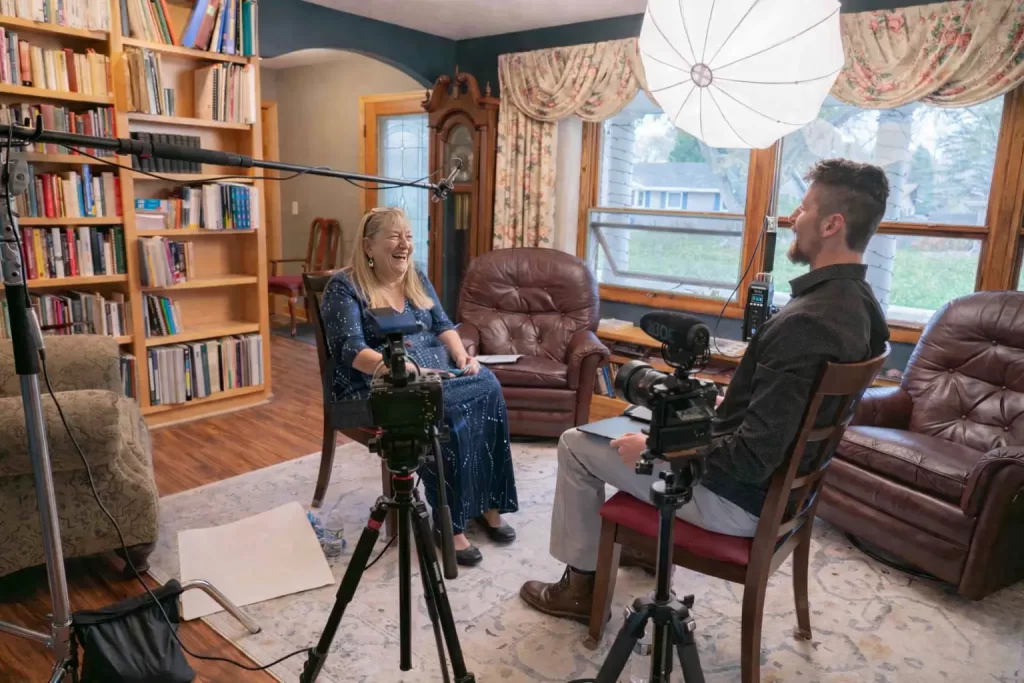 An interview with an elderly woman who is laughing and enjoying her time. She is in the middle of a Legacy Interview, a recorded interview about her life.